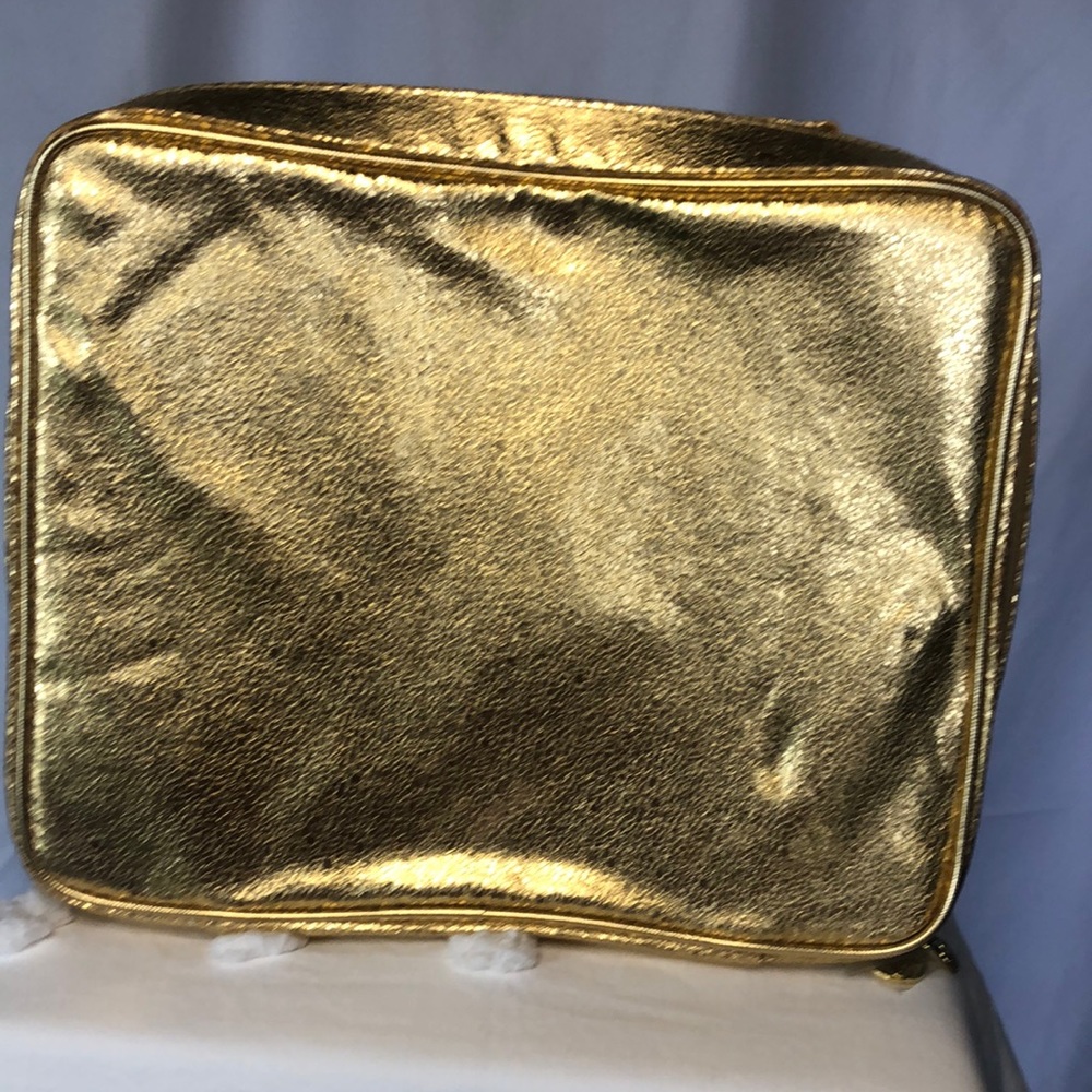 ESTEE LAUDER gold travel toiletry case.